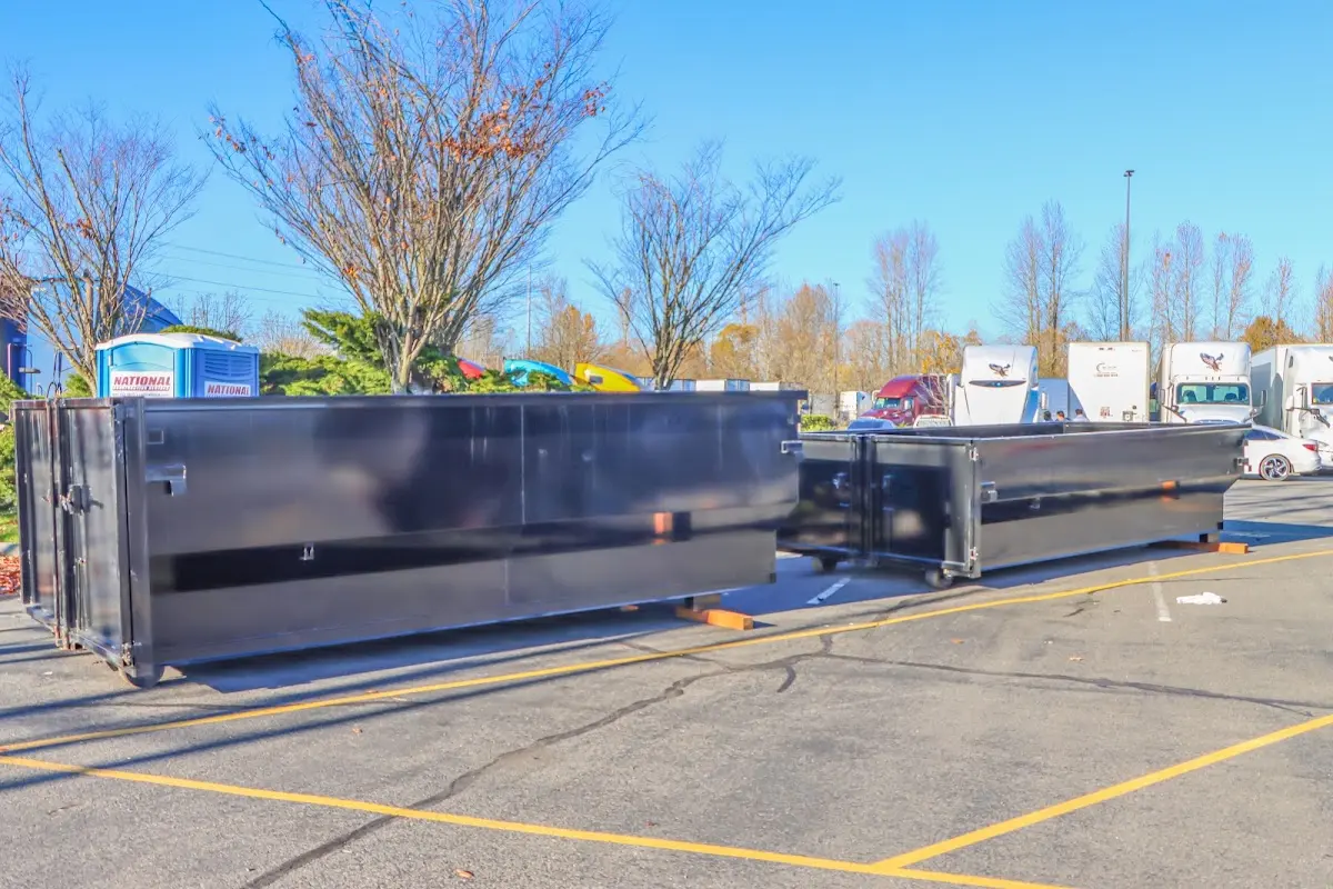 Professional dumpster rental service with roll-off container on residential driveway in Indiantown